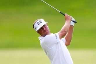 Keith Mitchell leads Trust after 61 course record. Loli 5 bags
