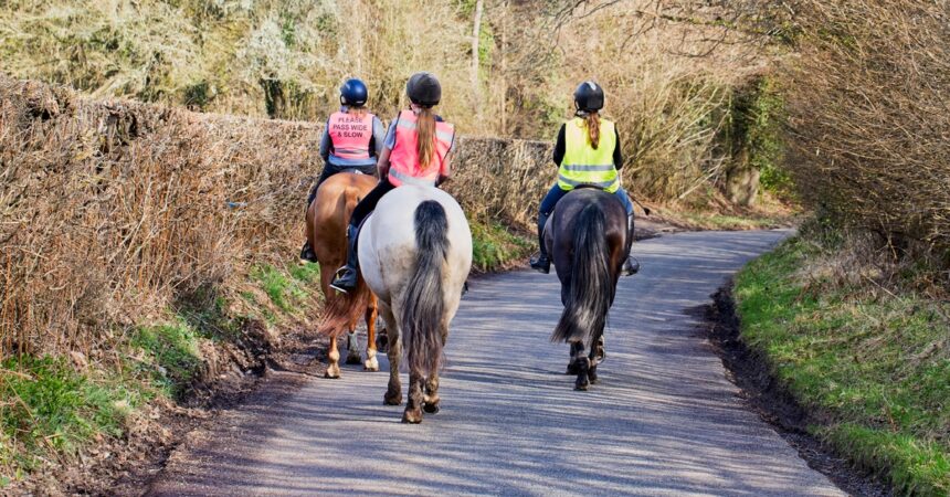 Three riders on the road.