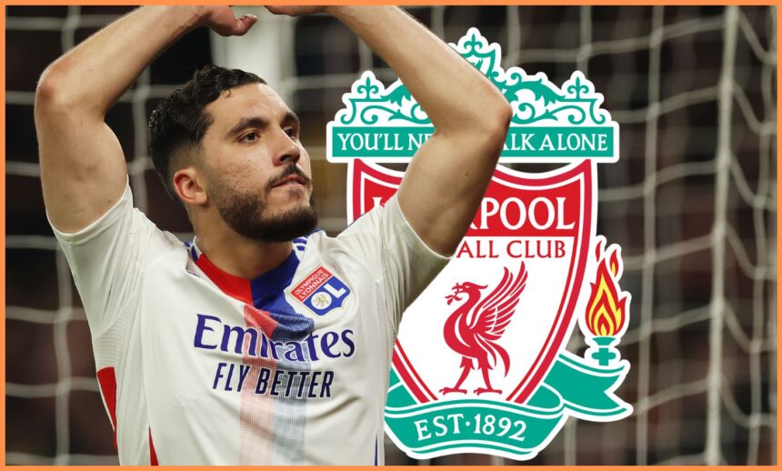 Rayan Cherki poses with his arms in the air in front of Liverpool club crest.