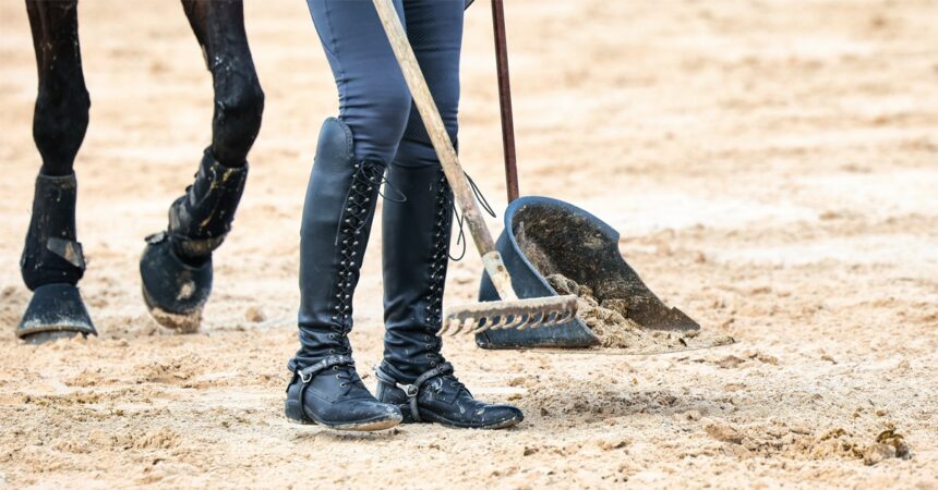 A rider picking up manure.