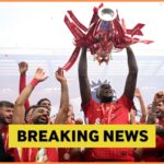 Ibrahima Konate lifts the Premier League trophy with Liverpool