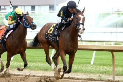 Michelle Elliott tries to keep the Indiana Oaks Trophy home at the top
