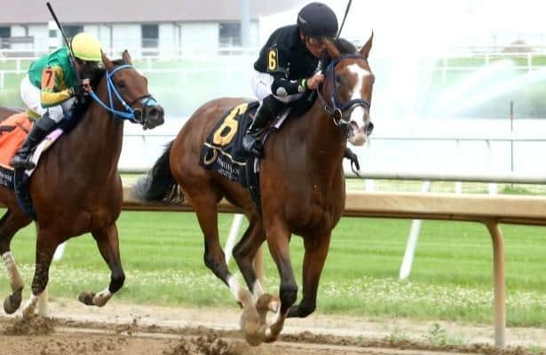 Michelle Elliott tries to keep the Indiana Oaks Trophy home at the top