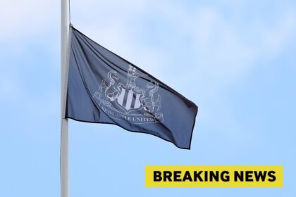 A Newcastle United flag and breaking news banner