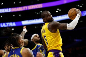 #5 Deandre Ayton of the Los Angeles Lakers spins into the basket against #0 Gary Payton II of the Golden State Warriors during the second quarter of a game at Crypto.com Arena.
