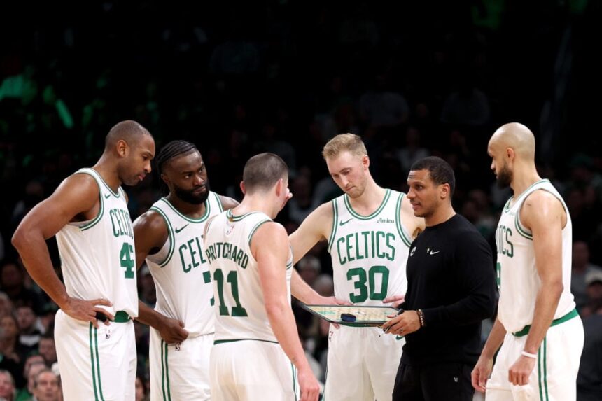 Boston Celtics head coach Joe Mazzula stands with Al Horford #42, Jaylen Brown #7, Peyton Pritchard #11, Sam Hauser #30, and Derrick White #9 during the second half of a game against the Portland Trail Blazers at TD Garden on March 5, 2025 in Boston, Massachusetts.