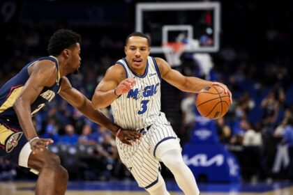 Desmond Bane #3 of the Orlando Magic dribbles the ball against Herbert Jones #2 of the New Orleans Pelicans during the first half of a preseason game.