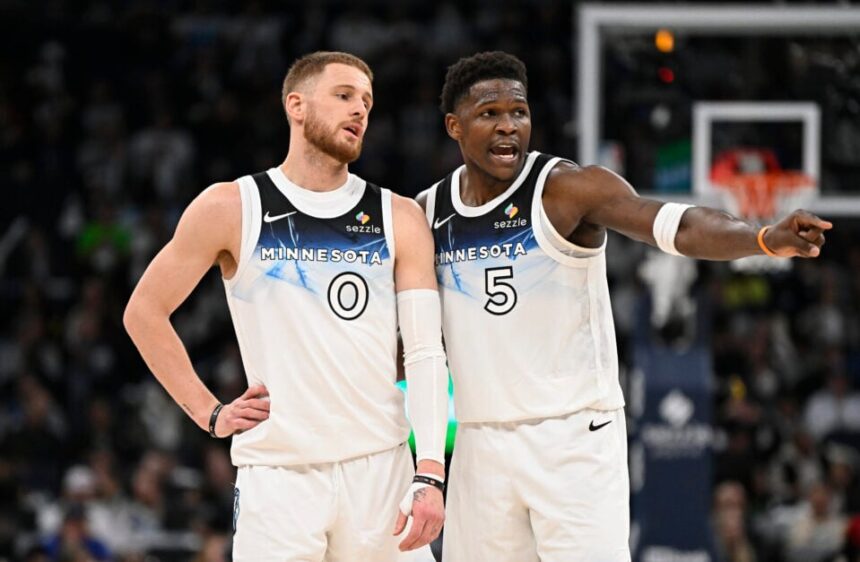 #0 Donte DiVincenzo of the Minnesota Timberwolves speaks with #5 Anthony Edwards during the second quarter of the game against the Brooklyn Nets at Target Center.