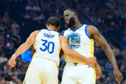 Golden State Warriors legends Draymond Green and Stephen Curry celebrate a good performance.