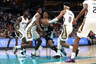 Ja Morant #12 of the Memphis Grizzlies goes to the basket against Jeremiah Fears #0 of the New Orleans Pelicans in the first half at FedExForum.