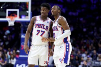 VJ Edgecomb #77 speaks with Tyrese Maxey #0 of the Philadelphia 76ers during the game between the Philadelphia 76ers and the Minnesota Timberwolves at Xfinity Mobile Arena.