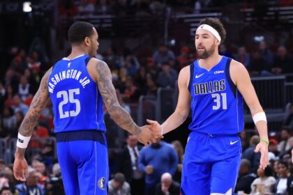PJ Washington #25 of the Dallas Mavericks reacts with Klay Thompson #31 during the first half of a game against the Chicago Bulls at the United Center on March 29, 2025 in Chicago, Illinois.