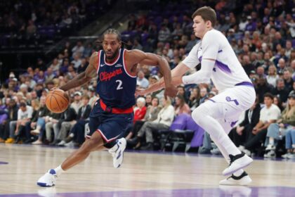 Kawhi Leonard #2 of the Los Angeles Clippers dribbles the ball around #24 Walker Kessler of the Utah Jazz during the first half of a game at Delta Center on October 22, 2025 in Salt Lake City, Utah.