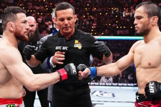 Merab Dvalishvili and Umar Nurmagomedov touch gloves just before their UFC 311 title fight