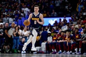 Denver Nuggets #0 Christian Braun dribbles during the first half against the Utah Jazz