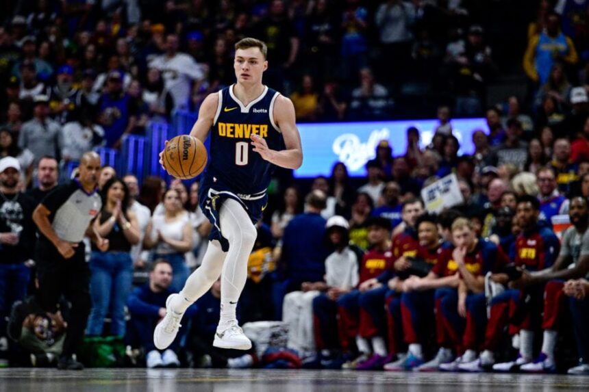 Denver Nuggets #0 Christian Braun dribbles during the first half against the Utah Jazz