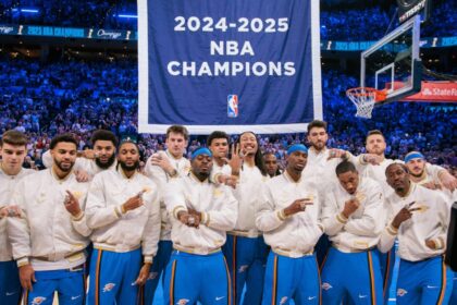 Oklahoma City Thunder players pose with their rings in front of a championship banner before a game against the Houston Rockets at Paycom Center.