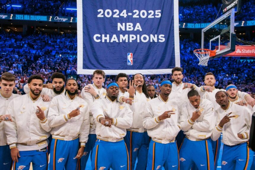 Oklahoma City Thunder players pose with their rings in front of a championship banner before a game against the Houston Rockets at Paycom Center.
