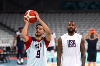 Tyrese Haliburton of the U.S. team takes a shot next to teammate LeBron James during a basketball training session for the 2024 Paris Olympics.