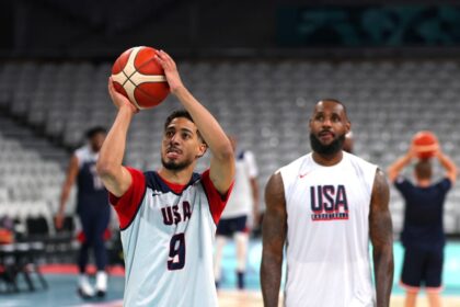 Tyrese Haliburton of the U.S. team takes a shot next to teammate LeBron James during a basketball training session for the 2024 Paris Olympics.