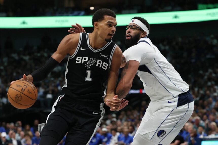 Victor Wenbanyama #1 of the San Antonio Spurs is defended by Anthony Davis #3 of the Dallas Mavericks during the first half at American Airlines Center.