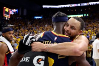 Stephen Curry #30 and Jimmy Butler III #10 of the Golden State Warriors celebrate after defeating the Houston Rockets 109-106 in Game 4 of the Western Conference First Round NBA Playoffs.