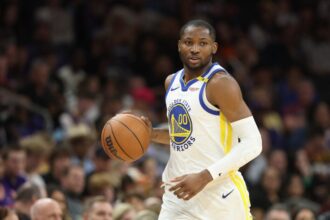 Jonathan Kuminga #00 of the Golden State Warriors handles the ball during an NBA game at PHX Arena.