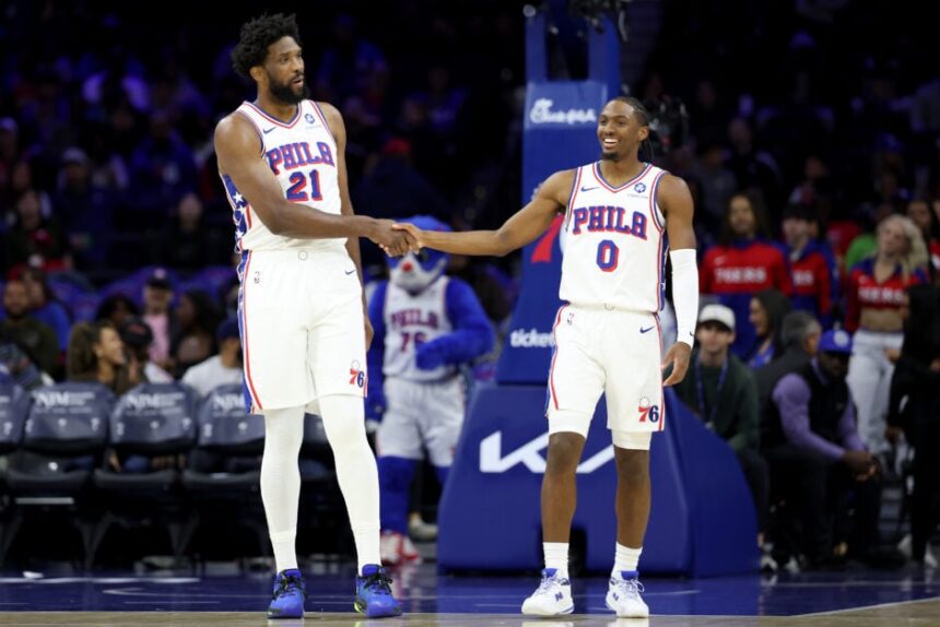 Joel Embiid #21 shakes hands with Tyrese Maxey #0 of the Philadelphia 76ers during the game between the Philadelphia 76ers and the Minnesota Timberwolves at Xfinity Mobile Arena.