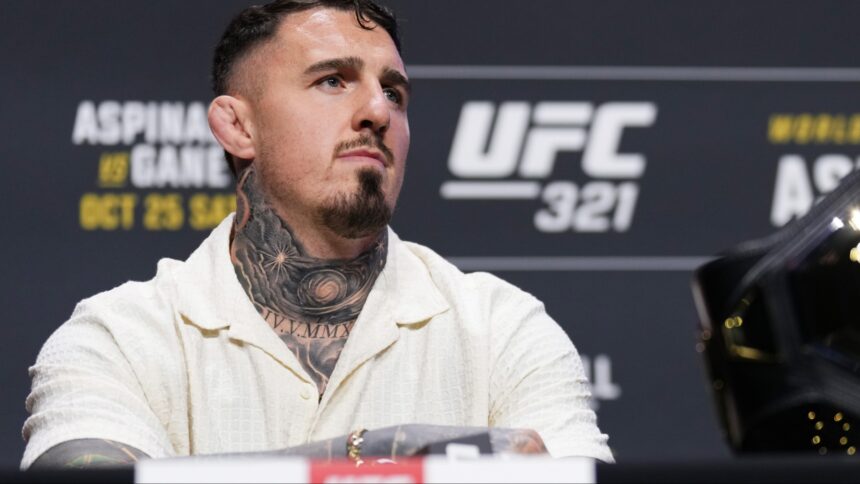Tom Aspinall appears at a pre-fight press conference for UFC 321