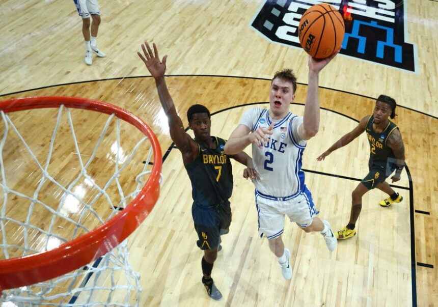 No. 2 Cooper Flagg of the Duke Blue Devils attempts a shot against No. 7 VJ Edgecombe of the Baylor Bears during the second round of the NCAA men's basketball tournament at Lenovo Center on March 23, 2025 in Raleigh, North Carolina.