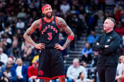 Brandon Ingram #3 of the Toronto Raptors and head coach Darko Rajkovic smile during a break in play during the second half of a basketball game against the Washington Wizards at Scotiabank Arena.