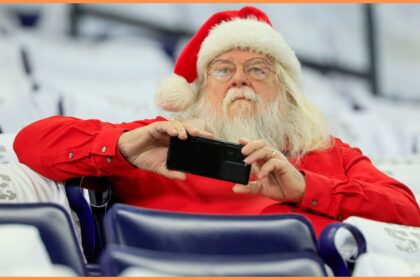 A fan dressed as Santa Claus at a football game