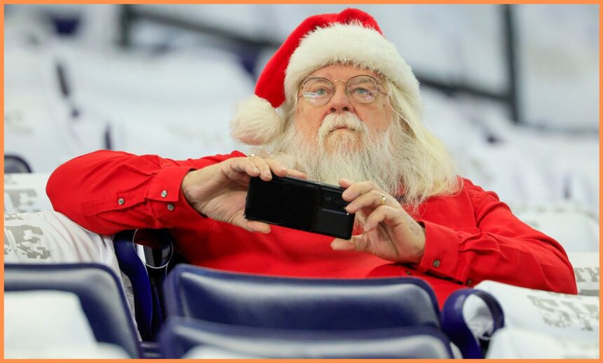 A fan dressed as Santa Claus at a football game