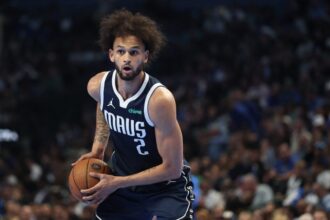 Derek Lively II #2 of the Dallas Mavericks handles the ball during the first half of the 2025-26 Emirates NBA Cup game against the Los Angeles Clippers at American Airlines Center.