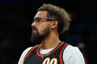 Trae Young, No. 11 of the Atlanta Hawks, watches the first half of an NBA game against the Phoenix Suns at Mortgage Matchup Center.