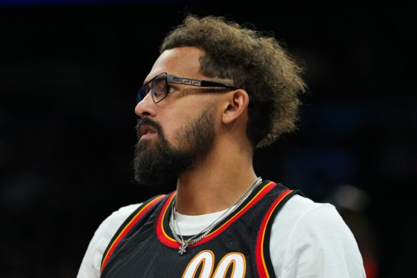 Trae Young, No. 11 of the Atlanta Hawks, watches the first half of an NBA game against the Phoenix Suns at Mortgage Matchup Center.