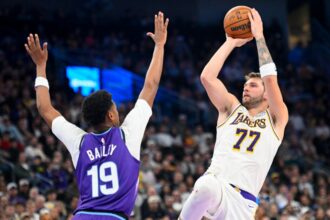 Los Angeles Lakers' No. 77 Luka Doncic shoots Utah Jazz's Ace Bailey No. 19 during the second half of a game at Delta Center on November 23, 2025 in Salt Lake City, Utah.