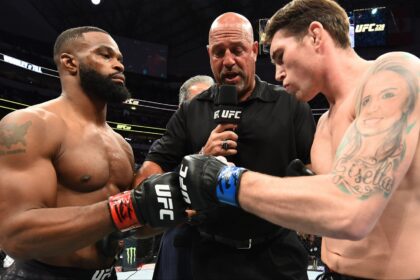 Tyron Woodley and Darren Till touch gloves in the Octagon