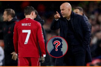 Florian Wirtz and Arne Slot talk on the touchline during Leeds vs Liverpool