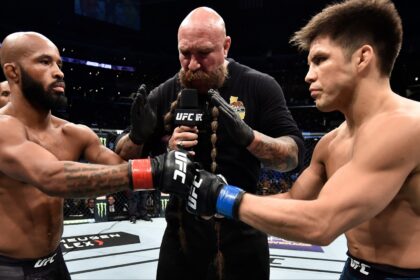 Demetrious Johnson and Henry Cejudo touch gloves just before their fight