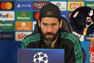 Alisson Becker giving press-conference with overlay of Salah against Leeds