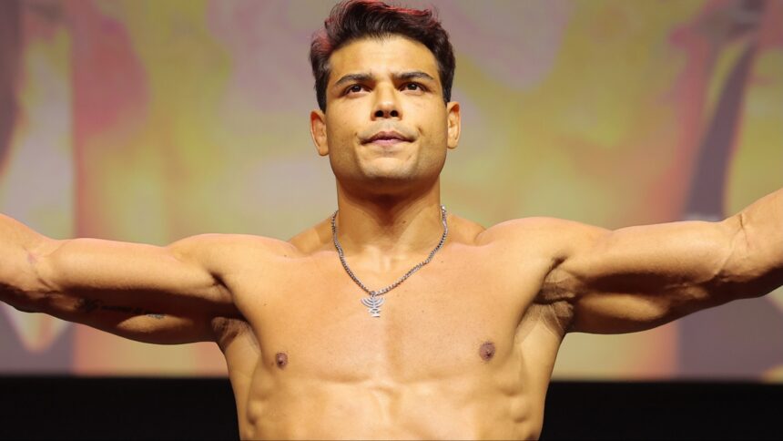 Paulo Costa poses on the scale at the UFC 318 ceremonial weigh-in