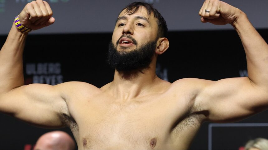 Dominick Reyes poses on the scale during the UFC Perth ceremonial weigh-in