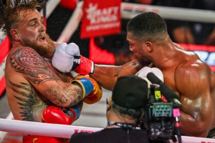 Anthony Joshua punches Jake Paul during their boxing match