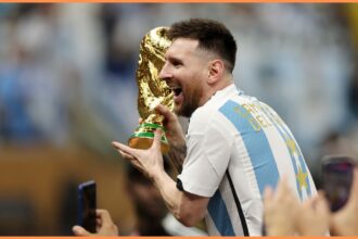 Lionel Messi celebrating with the World Cup trophy