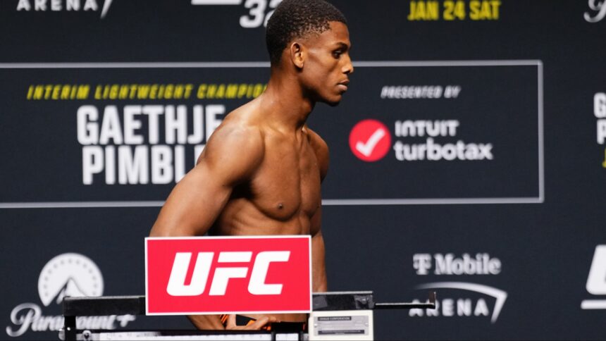 Cameron Smotherman poses on the scale at the UFC 324 official weigh-in