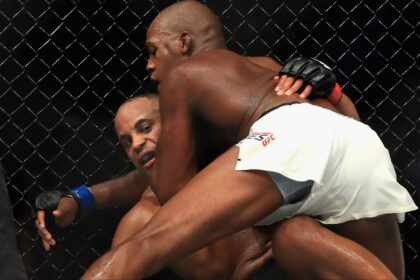 Jon Jones grapples with Daniel Cormier during their fight at UFC 214