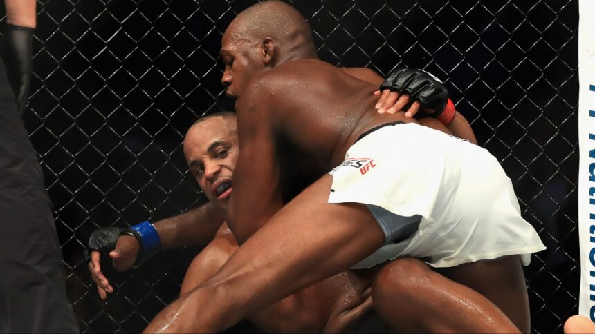 Jon Jones grapples with Daniel Cormier during their fight at UFC 214