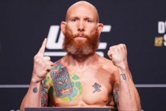 Josh Emmett poses on the scale at the UFC 320 ceremonial weigh-in