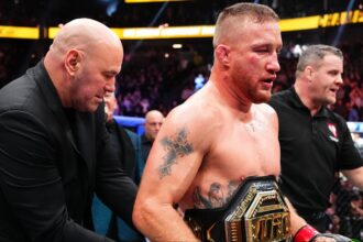 Justin Gaethje gets a UFC belt wrapped around his waist by Dana White at UFC 324